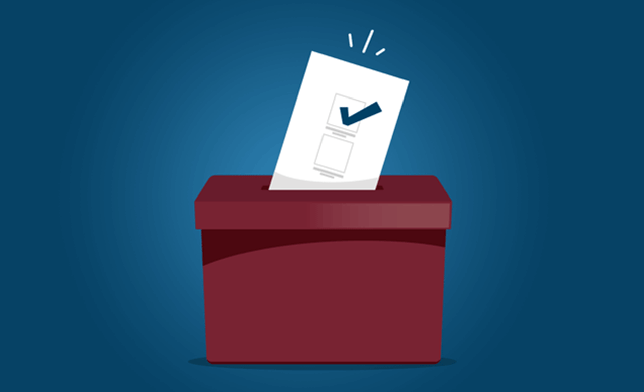 A voting ballot being placed into a ballot box
