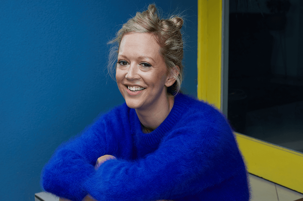 Woman in blue sweater smiling
