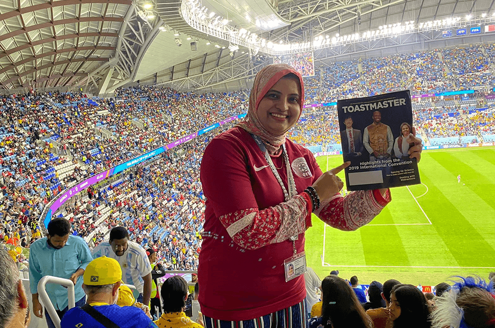 Woman holding magazine inside stadium at the FIFA World Cup Qatar 2022