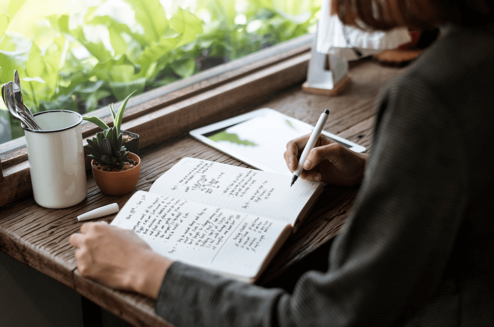 Woman writing in her journal