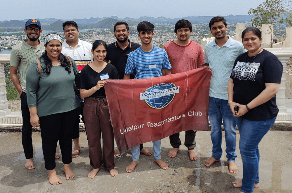 Group of people posing with banner after hike