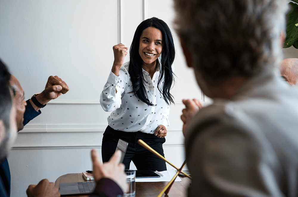 Woman giving enthusiastic speech to colleagues