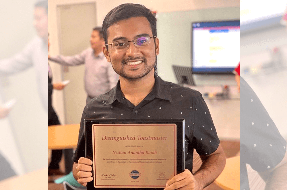 Young man smiling and holding DTM plaque