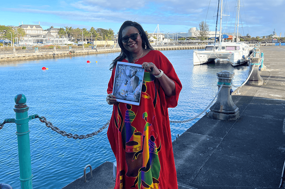 Woman holding magazine near water in Mauritius