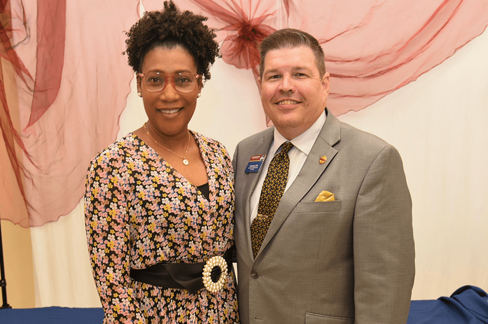 Pamela D. Rolle, DTM, poses with Toastmasters International President Matt Kinsey, DTM. Kinsey served in a District leadership role with Rolle, and succeeded her as District Governor from 2012–2013.