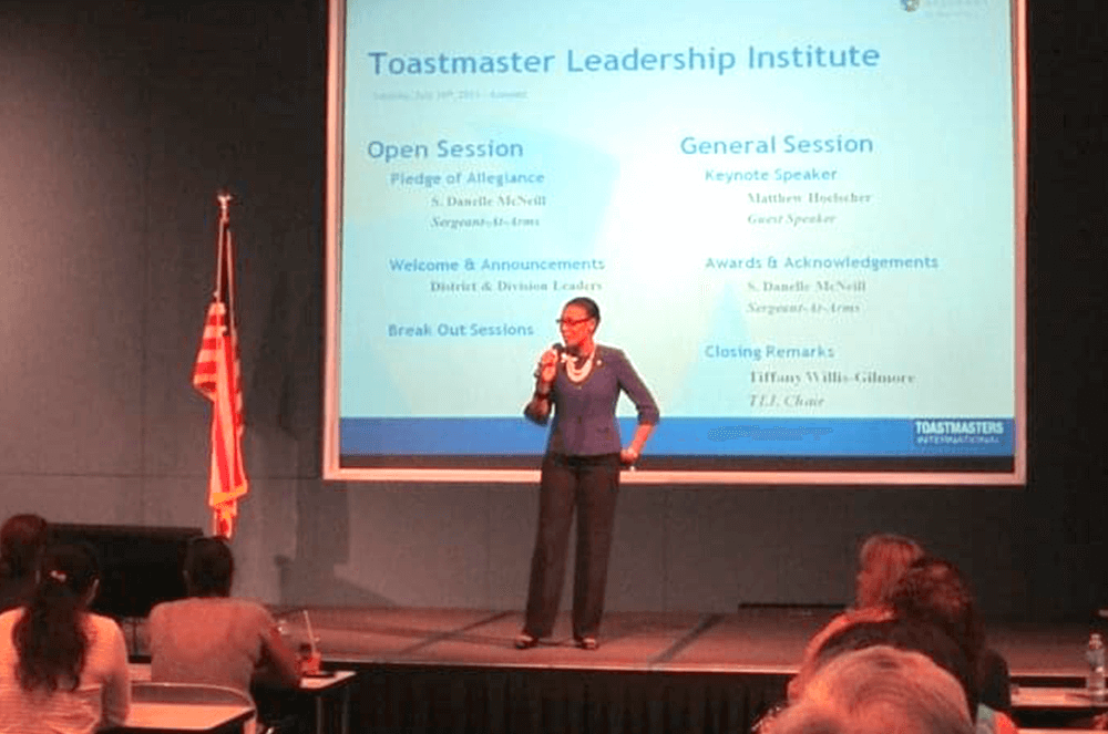 A Toastmaster for 23 years, Rolle has taken on many leadership opportunities. Here she is speaking onstage to a group of members during a Toastmasters Leadership Institute workshop.
