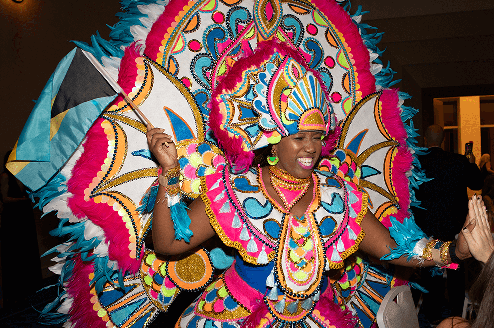Woman in colorful Bahamian attire dancing