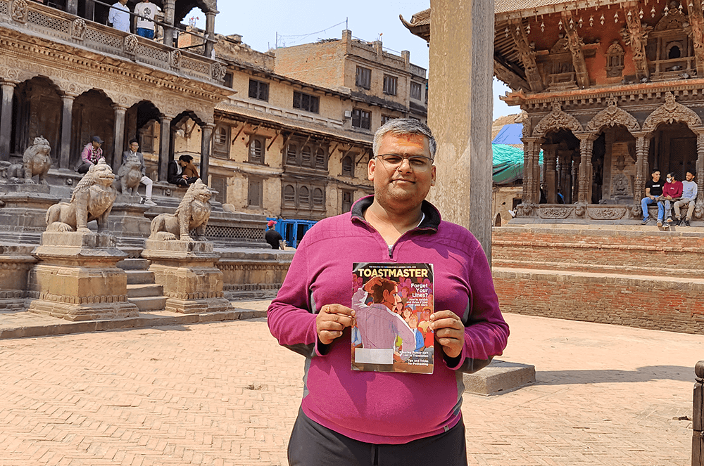 Man holding magazine in Patan Durbar Square in Nepal