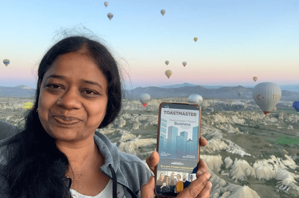 Woman holding iPhone while riding in hot air balloon in Turkey