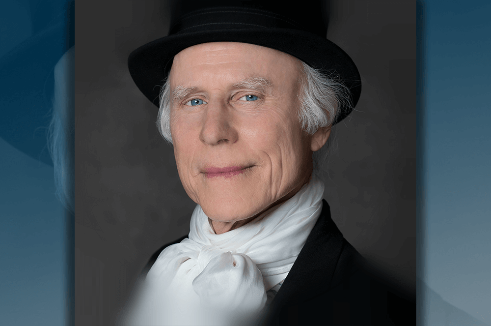 Man dressed in black top hat and white scarf