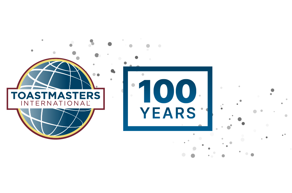 Toastmasters International globe logo next to 100 years in blue box surrounded by gray confetti