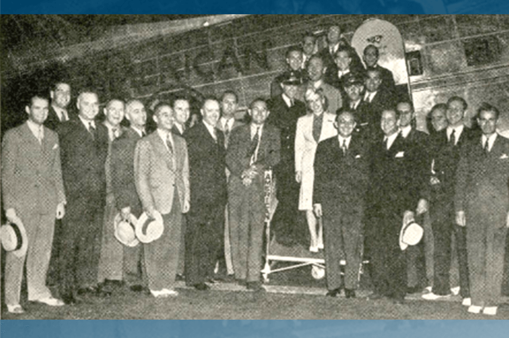 Black and white photo of group of men outside of transcontinental sleeper plane