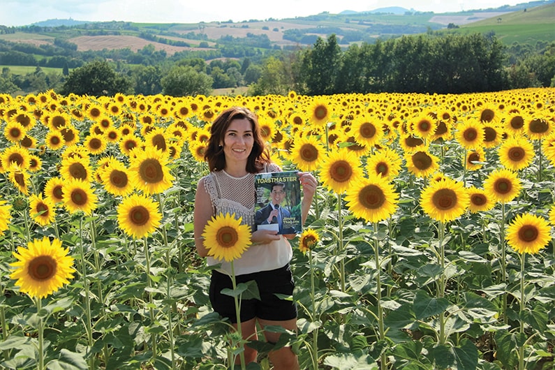 Anna Trach, from Kyiv, Ukraine, poses in a sunflower field in Italy. 
