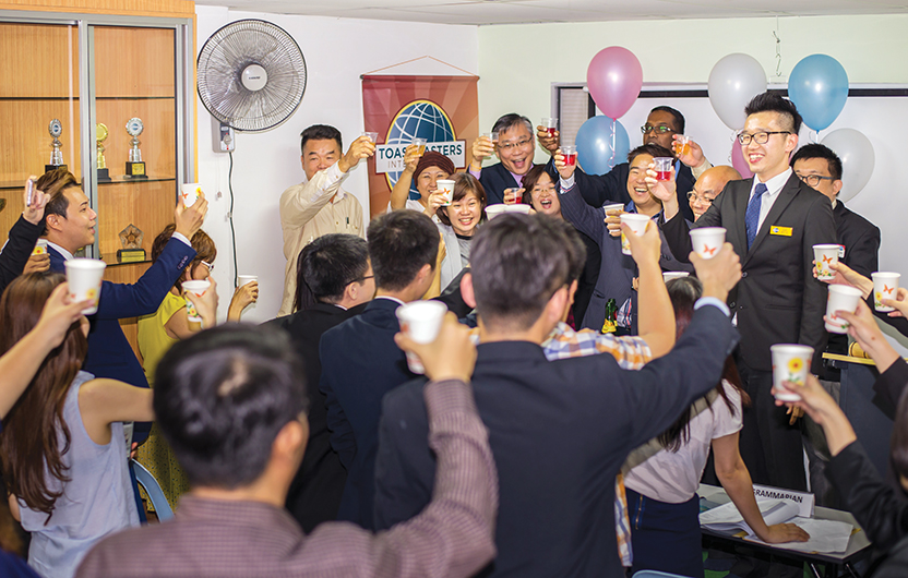 Members of Puchong English Toastmasters, in Selangor, Malaysia, toast to their 100th club meeting.