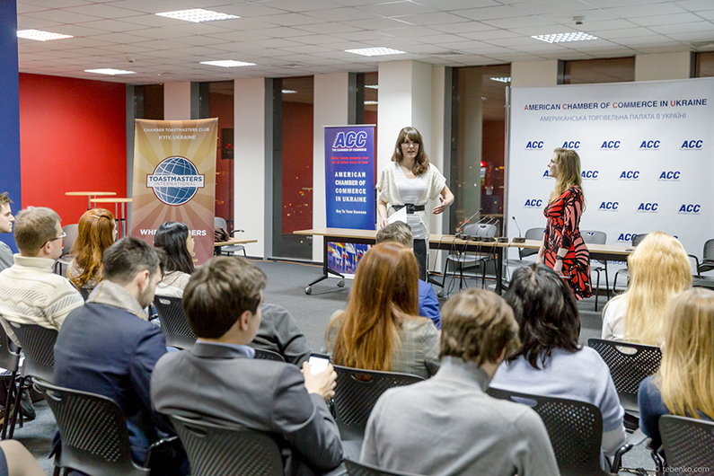 Guests of the Chamber Toastmasters club open house in Kiev, Ukraine, raise their hands to speak during a round of Table Topics.