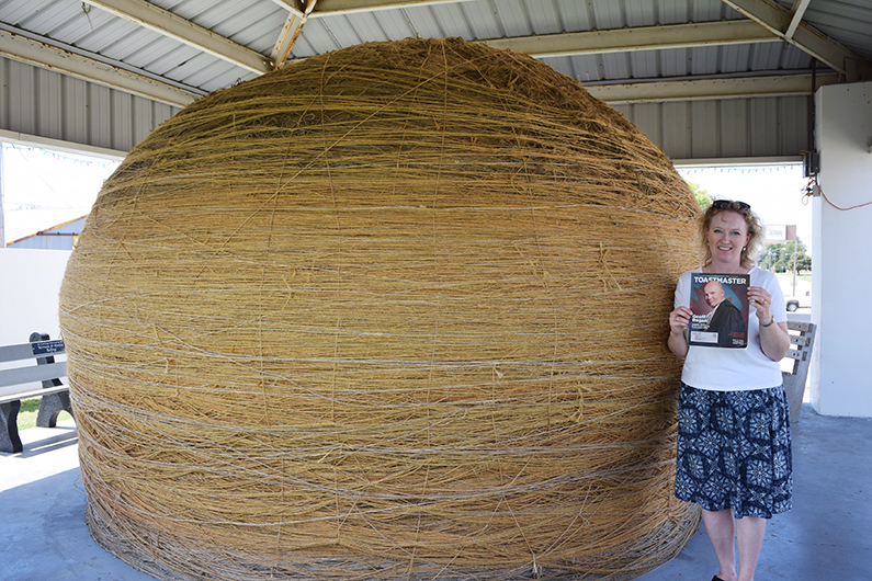 Teresa Cooper, DTM, from Winnipeg, Manitoba, Canada, stands next to the World’s Largest Ball of Sisal Twine in Cawker City, Kansas.