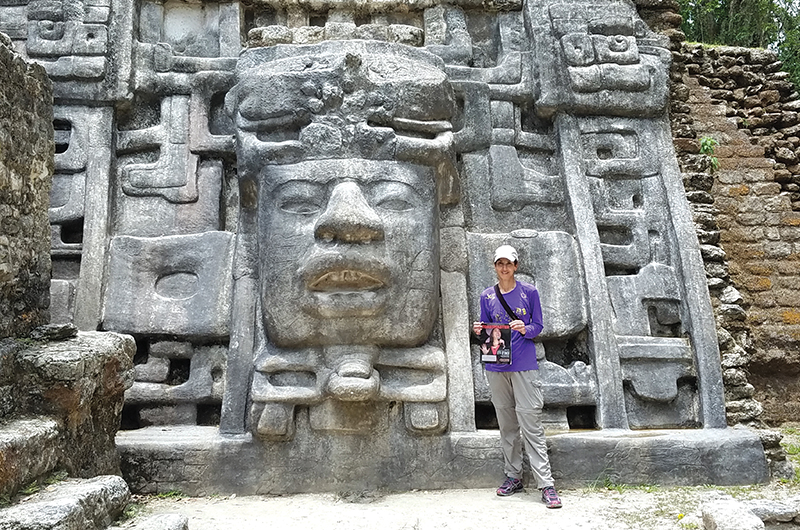 Vera Ambrosio, from Simi Valley, California, poses in front of Mask Temple at the archaeological site of Lamanai in Belize.