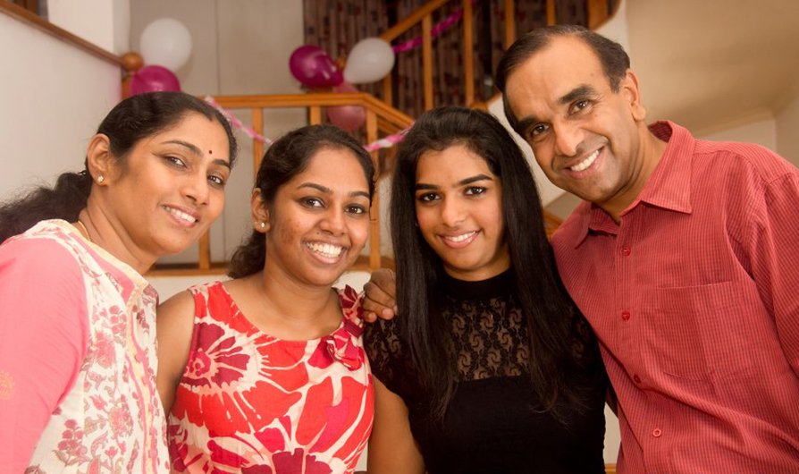From left to right: Saru, Avisha, Mahishaa and Balraj Arunasalam pose as a family at a party. (Photo credit: Dylan Seedin Photography)