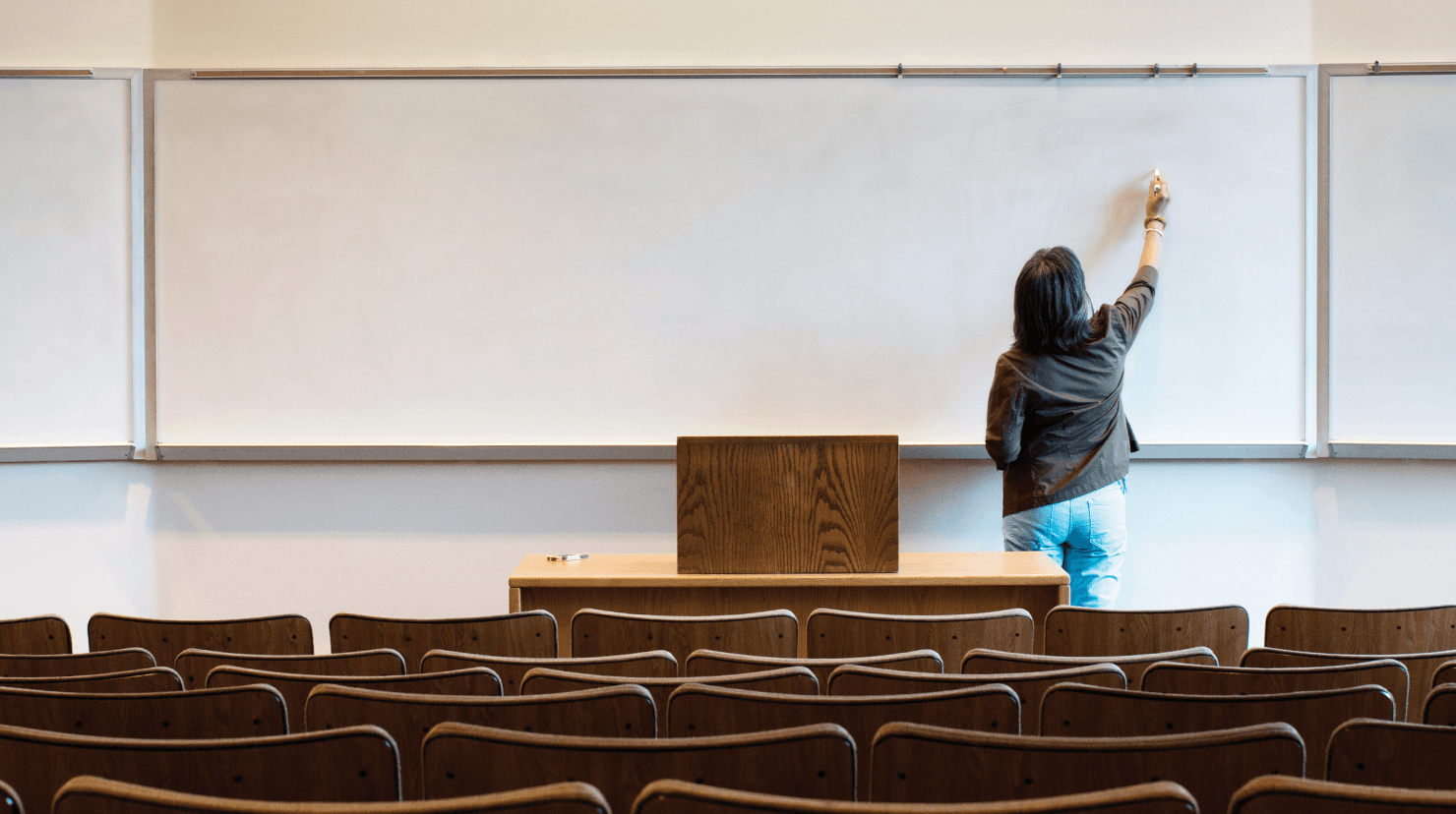 Woman writing on a white board