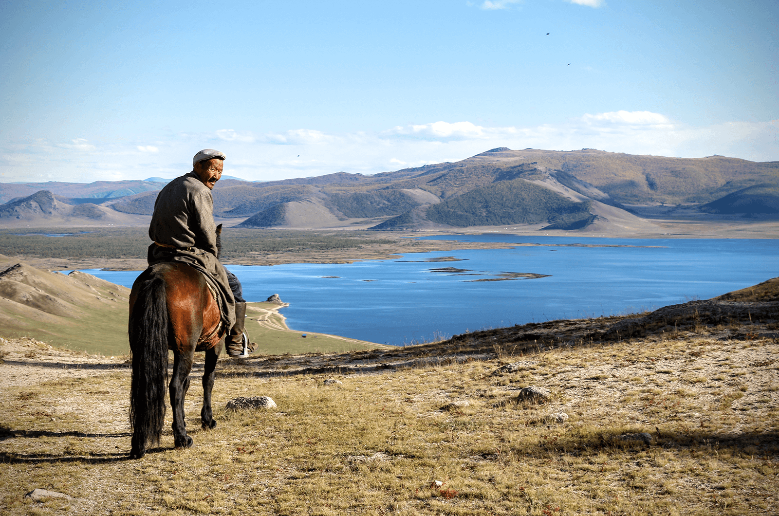 A local guide on a horse in Mongolia. Photo by Indy Guide. 