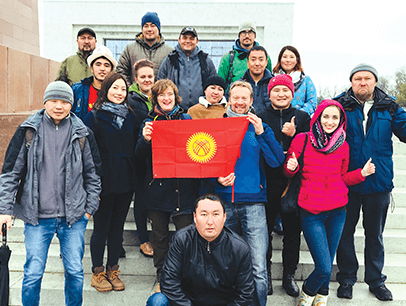 Instructors from the tour-guide training company EastguidesWest with a group of tourism students holding the flag of Kyrgyzstan in the capital city of Bishkek. Photo by EastguidesWest