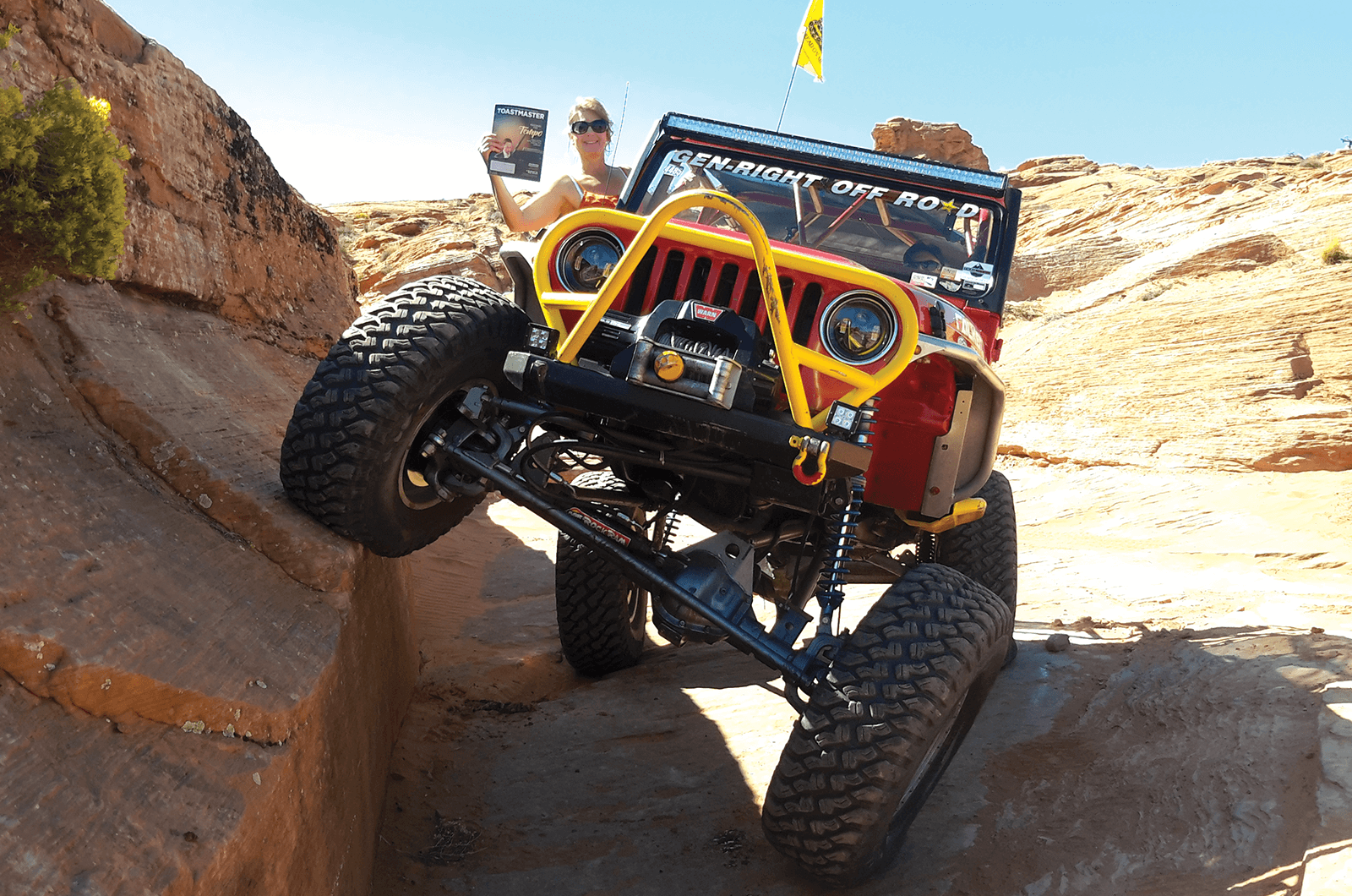 Marisa whittington, ACS, ALB, of Draper, Utah, hangs out of her off-road Jeep in the desert.
