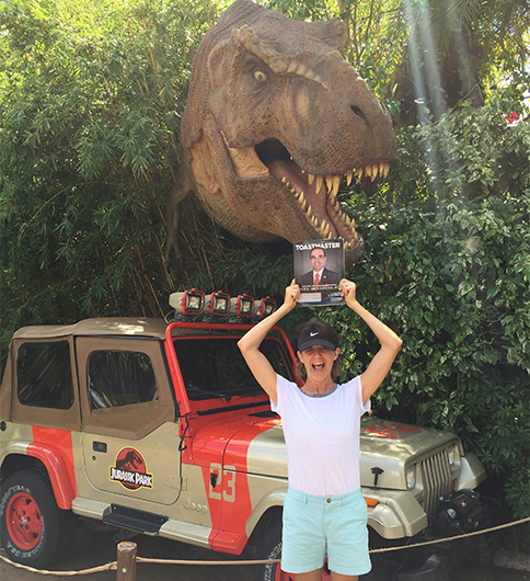 Nicole Smith, CC, CL, from Far Hills, New Jersey, poses in front of a Jurassic Park attraction at Universal Studios in Orlando, Florida.