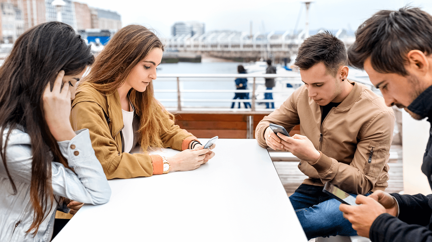 Friends at lunch on their phones