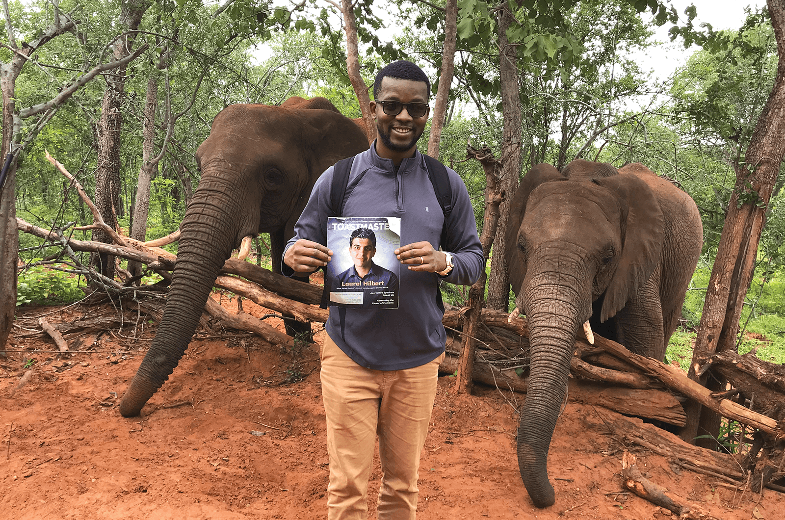 Gregory Gabriel, CC, from West Palm Beach, Florida, poses with elephants at the Wild Horizon Elephant Sanctuary at Victoria Falls National Park in Zimbabwe.