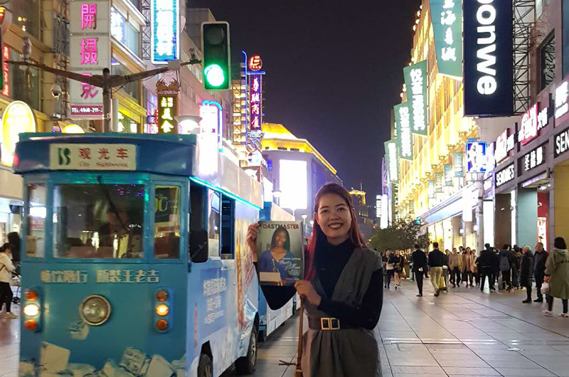 Donnabel Cantila, CC, CL, from Dubai, United Arab Emirates, poses in the busy streets of Shanghai, China, while on a work trip.