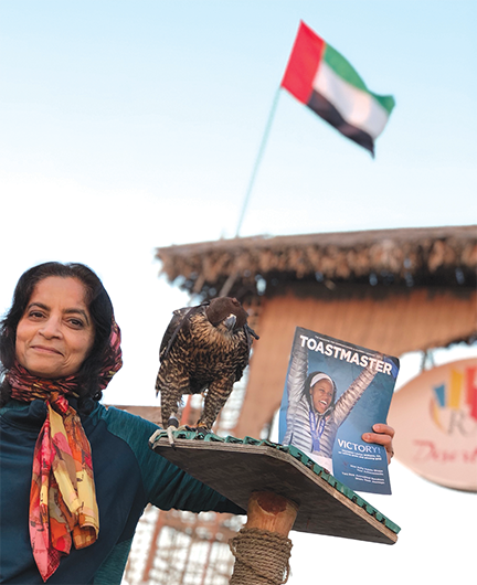 Farzana Chohan, DTM, a 2018–2019 region advisor from Chesterfield, Missouri, meets a peregrine falcon during a desert safari in Dubai, United Arab Emirates.