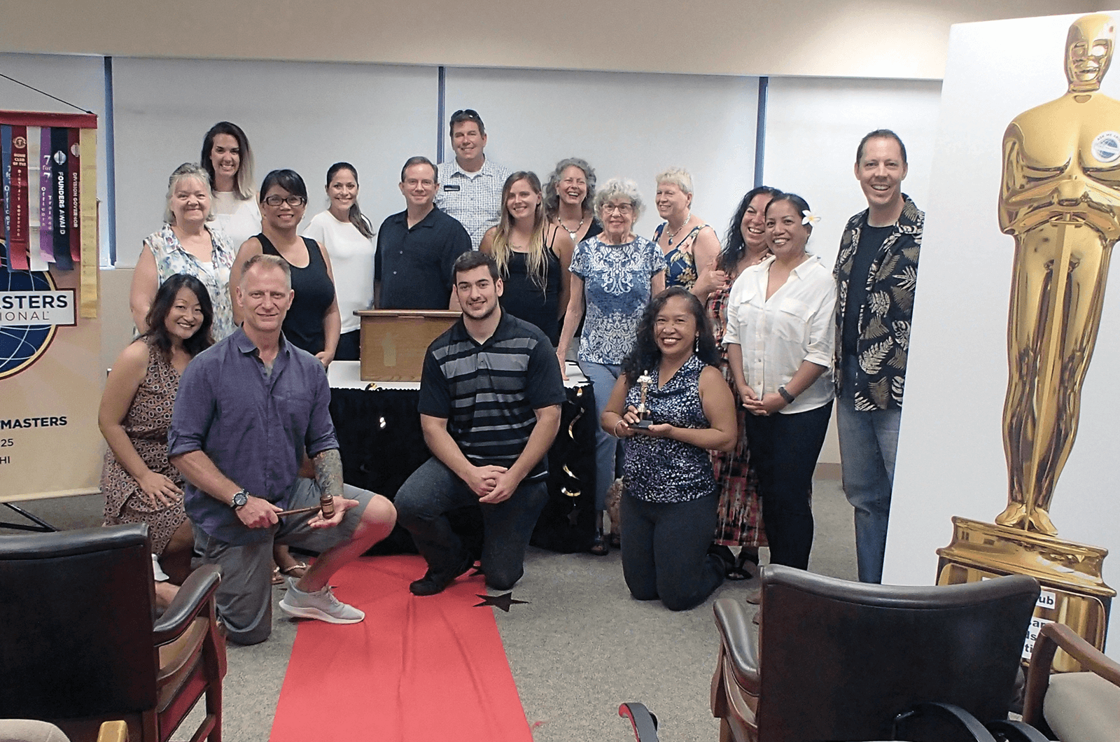 Kauai Toastmasters club gather on red carpet for awards-themed meeting