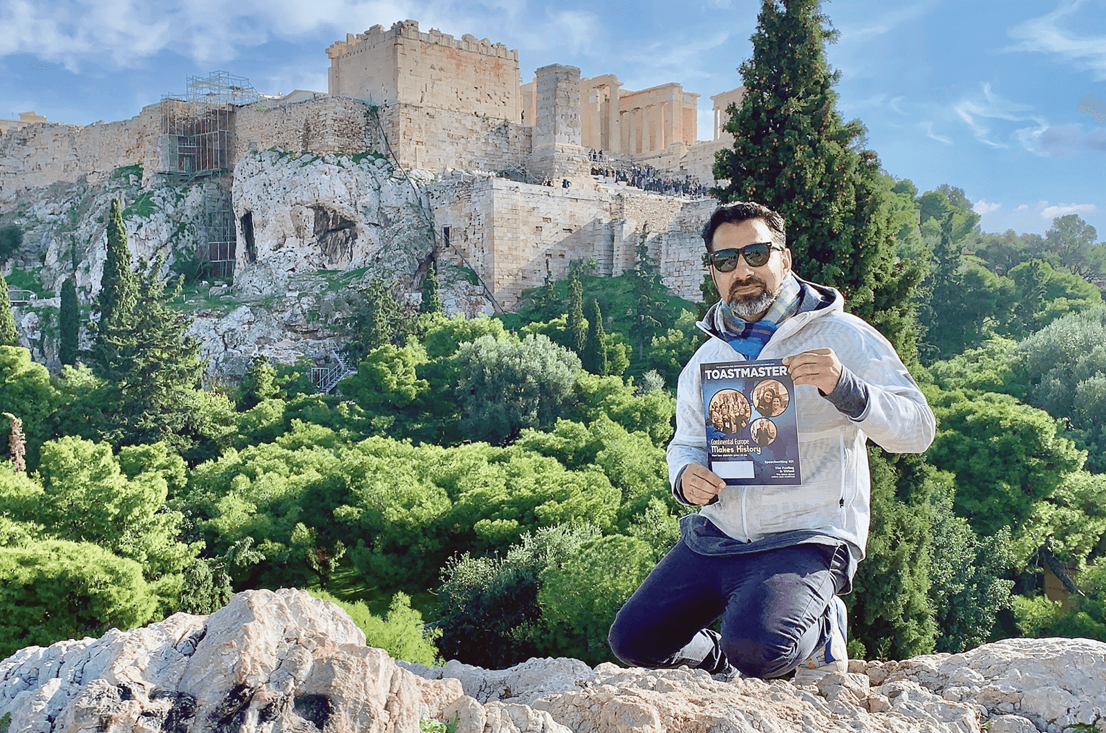 Amjad Ali of Dubai, United Arab Emirates, sits below the Acropolis of Athens, Greece, an ancient citadel perched above the city.