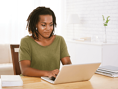 Woman in green shirt on laptop