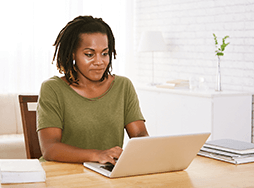 Woman in green shirt on laptop