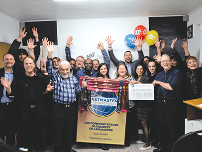Group of Toastmasters member with hands in the air celebrating in Canada
