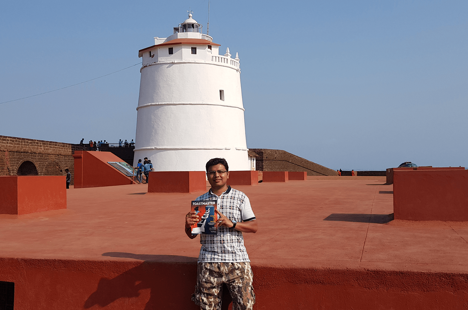 Dhaval Sharma of Ahmedabad, India, stands in front of Fort Aguada and its lighthouse. This well-preserved 17th century Portuguese fort is in Goa, India, on Sinquerim Beach, which overlooks the Arabian Sea. 