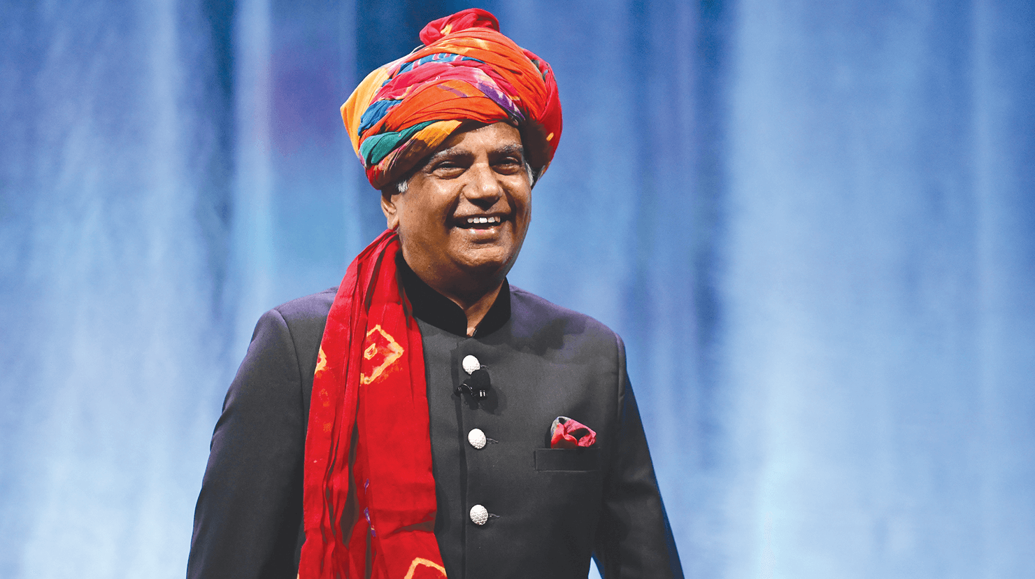 Toastmasters International President Deepak Menon smiling onstage