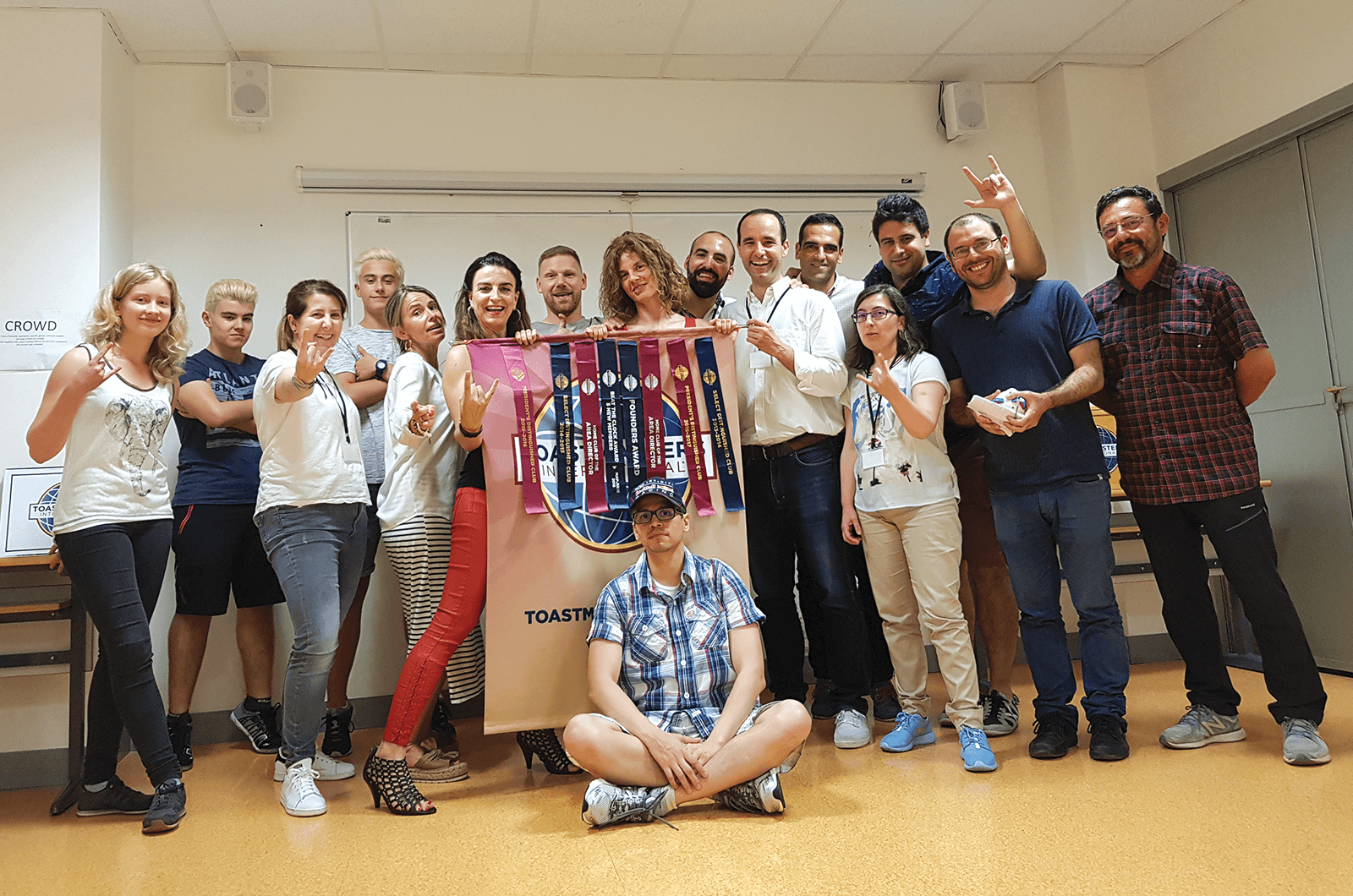 Group of Toastmasters members in Spain pose with banner