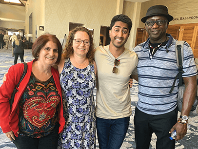 Four people pose together at annual convention