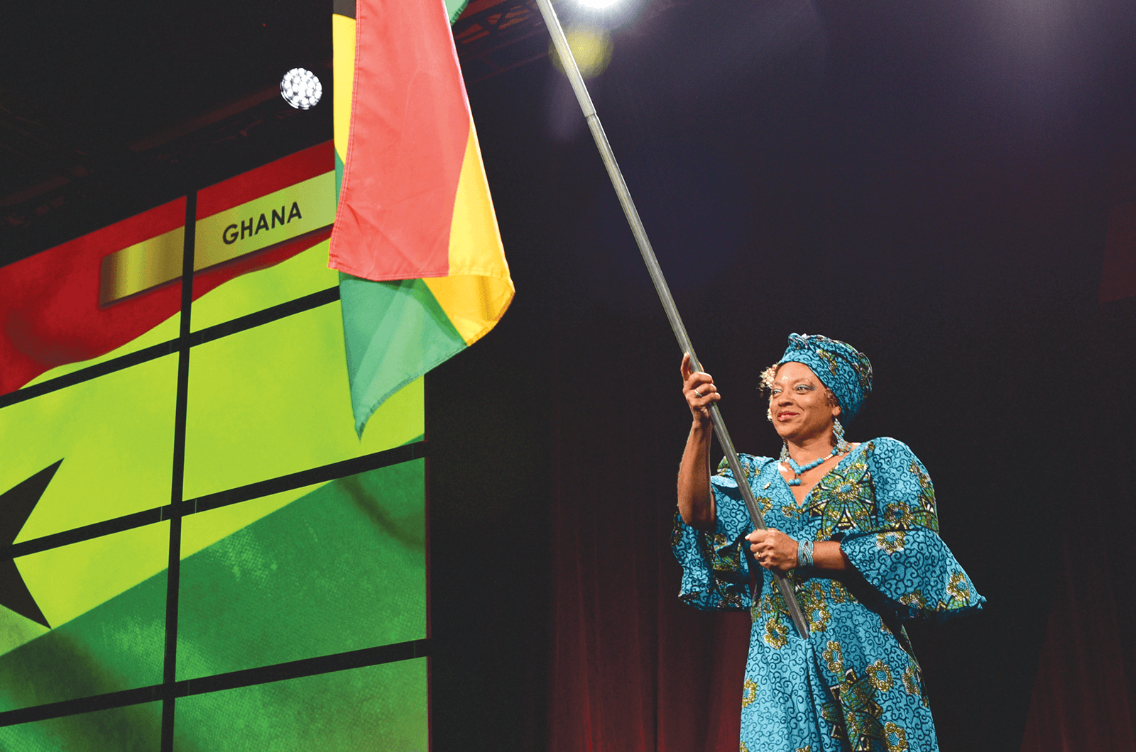 A Toastmaster from Ghana holds the country flag during Opening Ceremonies.