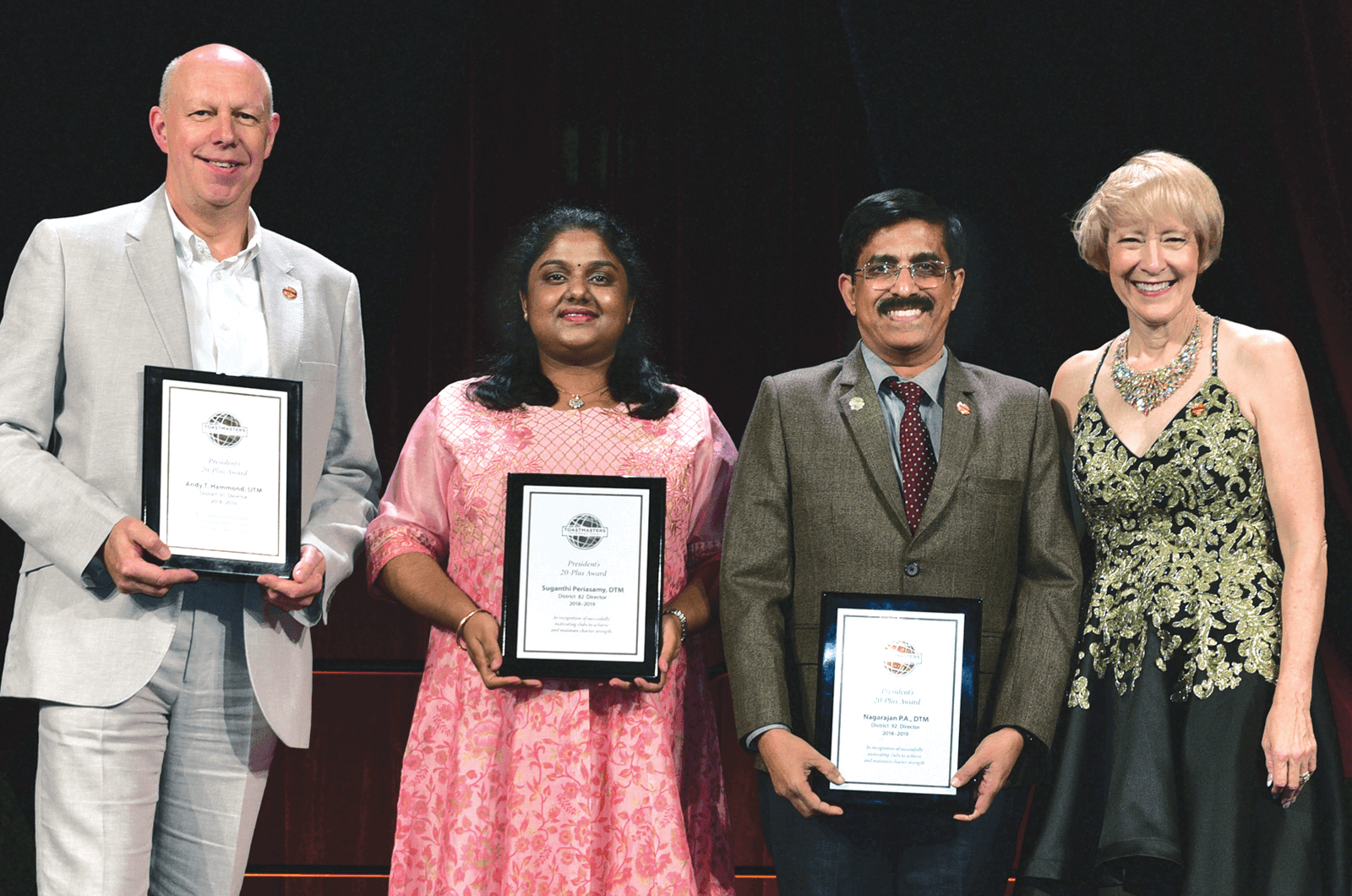 Lark Doley (right) presents the President’s 20-Plus award to the top three districts.