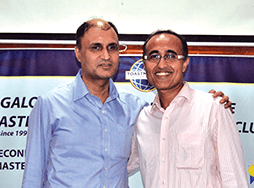 Man in blue shirt posing with mentor