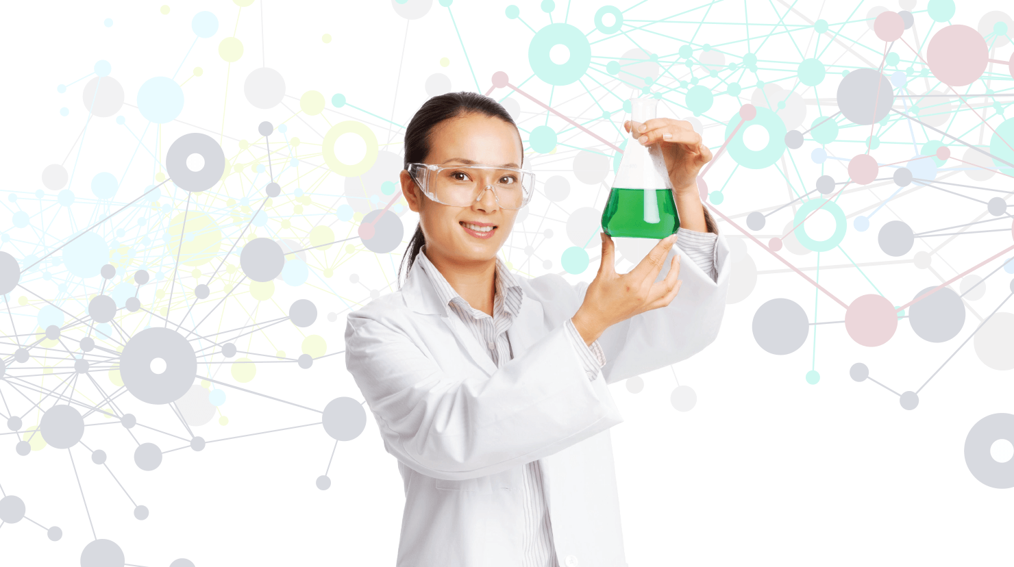 Woman in white lab coat holding beaker