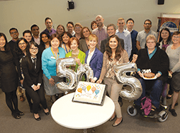 Group of Toastmasters members with silver balloons spelling out 505