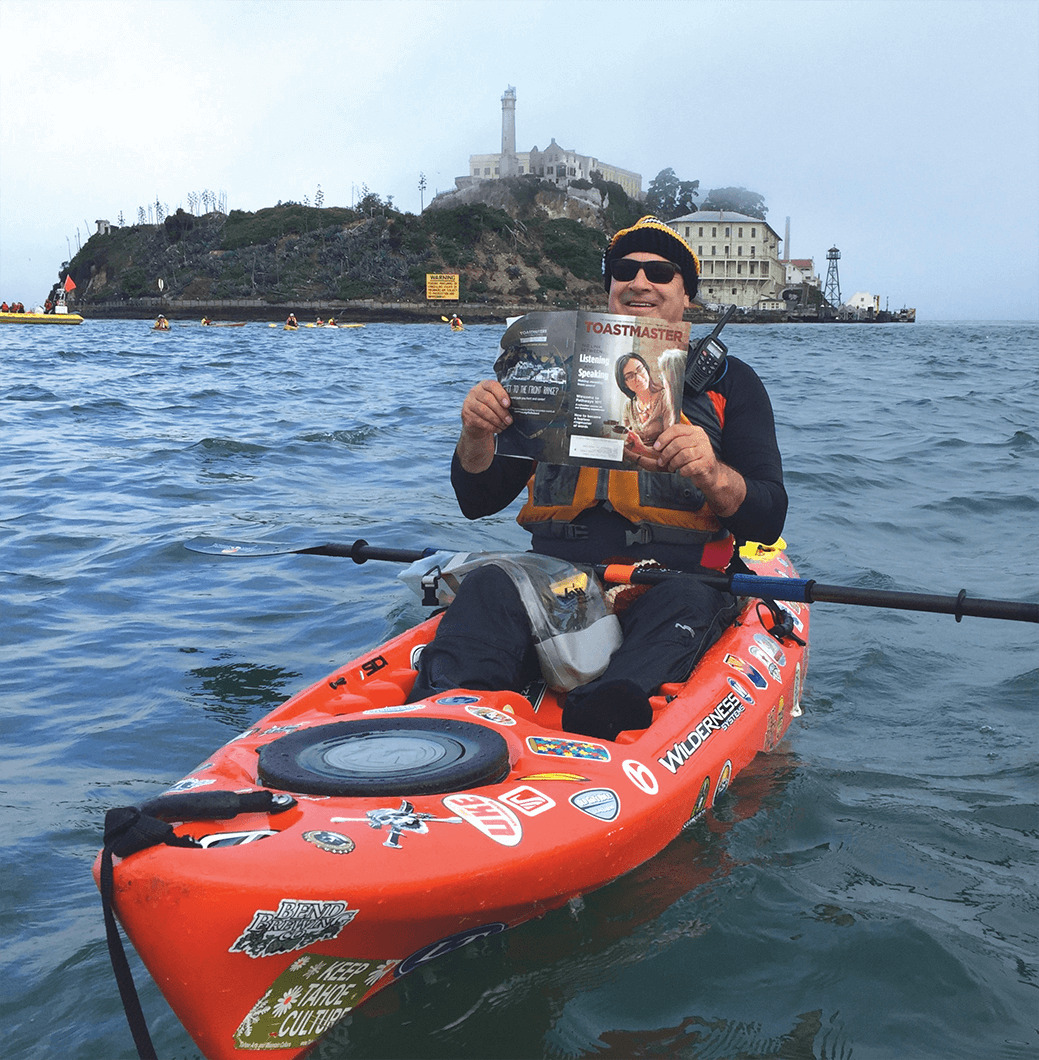 Bill Schmalzel of Sacramento, California, assists with safety support from his kayak for participants in an “open water swim” in the San Francisco Bay near Alcatraz Island in California. 