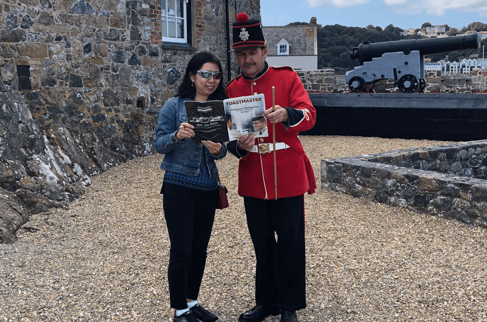 Lisa Yang of Orlando, Florida, reads the Toastmaster with an actor in the gun show at the Castle Cornet in Saint Peter Port part of Guernsey, Channel Islands.