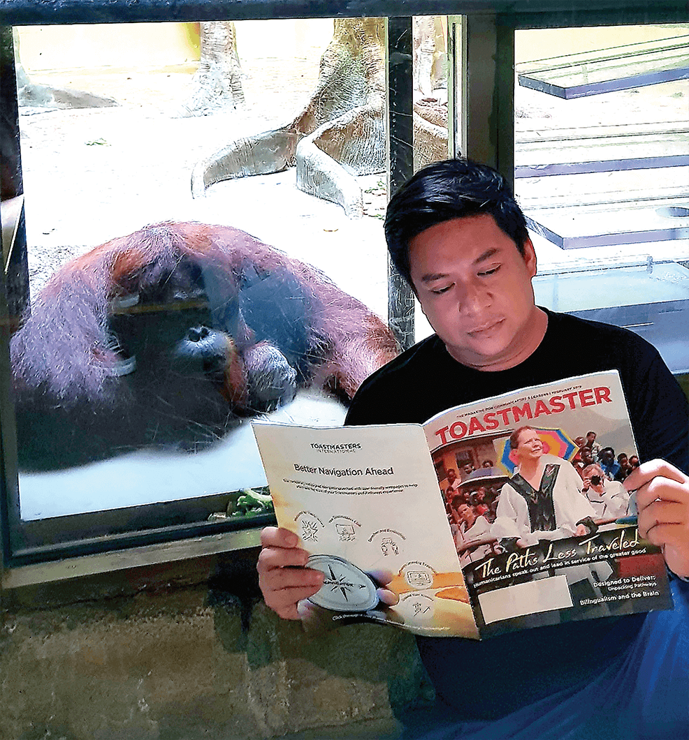 Andrew Ceniza of Cebu City, Philippines, reads his magazine with a friend in Seoul, South Korea.