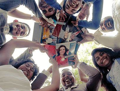 Toastmasters members looking down at camera holding manuals