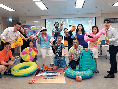 Group of Toastmasters members with beach-themed props